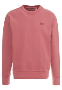Sweatshirt rose en coton doux. Il possède un col rond, des manches longues et un petit logo embossé sur le devant. Tissu texturé.