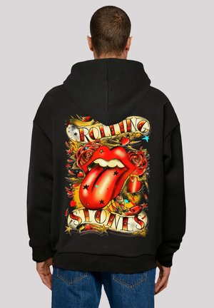 Black hoodie featuring a large, multicolored graphic on the back, depicting a red tongue and roses, with "Rolling Stones" text in bold.