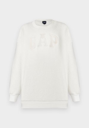Witte fleece trui met een ronde hals, voorzien van een reliëf "GAP" logo in beige. Lange mouwen met geribbelde manchetten en zoom. Zachte textuur.