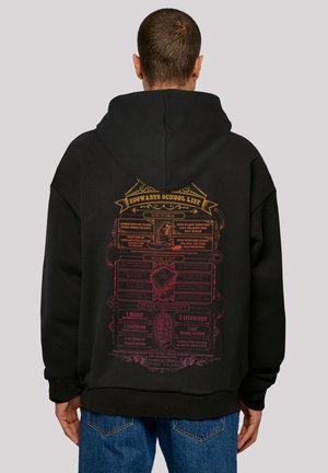 Black hoodie with a large colorful graphic on the back featuring the "Hogwarts School List," showcasing uniform and equipment details.