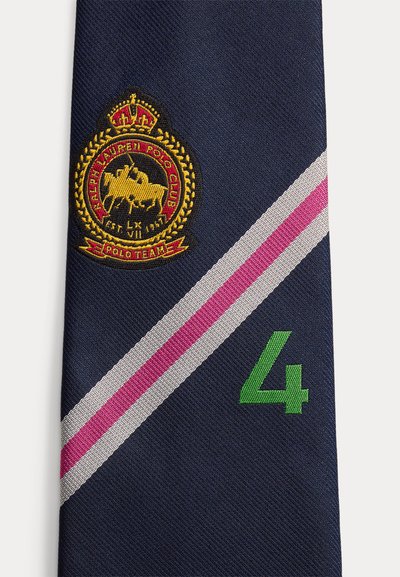 Γραβάτα σε ναυτικό μπλε με διαγώνιες λευκές και ροζ ρίγες, πράσινος αριθμός 4, και κεντημένο έμβλημα του Ralph Lauren Polo Club που απεικονίζει κορώνα και παίκτη πολο.