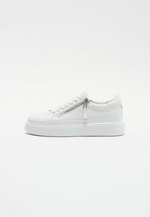 White sneaker with a textured upper, round toe, and platform sole. Features a side zipper and lace closure for added detail.