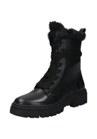 Schwarzer Lederkampfstiefel mit dickem Sohlen, schwarzen Schnürsenkeln und schwarzem Fellbesatz am Knöchel, schräg positioniert, um die Außenseite und die Vorderseite zu zeigen.
