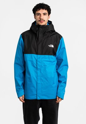 Farbe-blockierte Jacke in Schwarz und leuchtendem Blau, mit Kapuze, Frontreißverschluss und Logo. Hergestellt aus leichtem, glattem Stoff.
