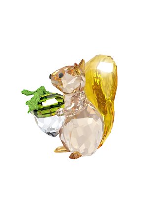 Crystal squirrel figurine, clear and amber hues, holding a green-accented acorn, faceted design showcasing light refraction and detail.