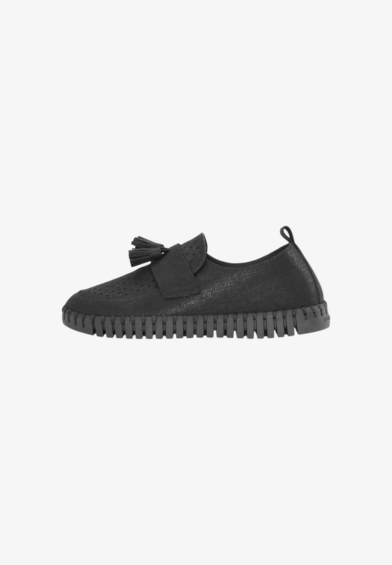 Zapatos negros de slip-on hechos de un material texturizado con perforaciones y un acento de borlas. Suela de goma con un patrón en forma de sierra.