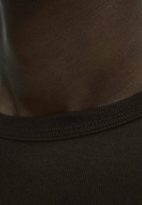 Black cotton t-shirt featuring a ribbed crew neckline, smooth texture, and close-up view of the fabric and neckline detail.