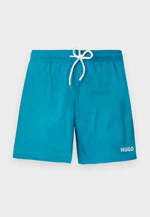 Vyriški žalsvai mėlyni maudymosi šortai su elastiniu juosmeniu, balta raišteliu ir baltu „HUGO“ logotipu kairėje kojoje.