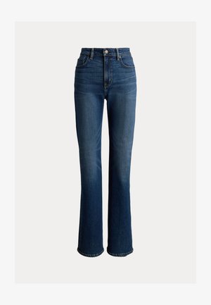 Τζιν ψηλόμεσο σε σκούρο μπλε με ελαφριά ξεθώριασμα, καμπάνες στα πόδια, πέντε τσέπες και λεπτομέρειες με εξαρτήματα σε χρυσή απόχρωση.