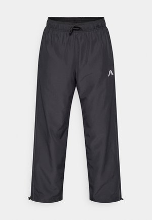 Pantalon de survêtement noir et léger avec taille élastique, cordon de serrage, ourlets à revers et logo blanc sur la cuisse gauche.