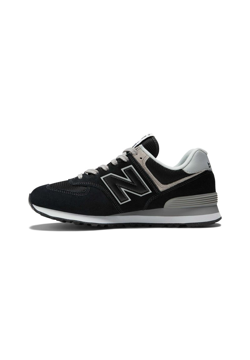 Black and grey New Balance sneaker with a suede and mesh upper, featuring a thick white sole and prominent 'N' logo on the side.