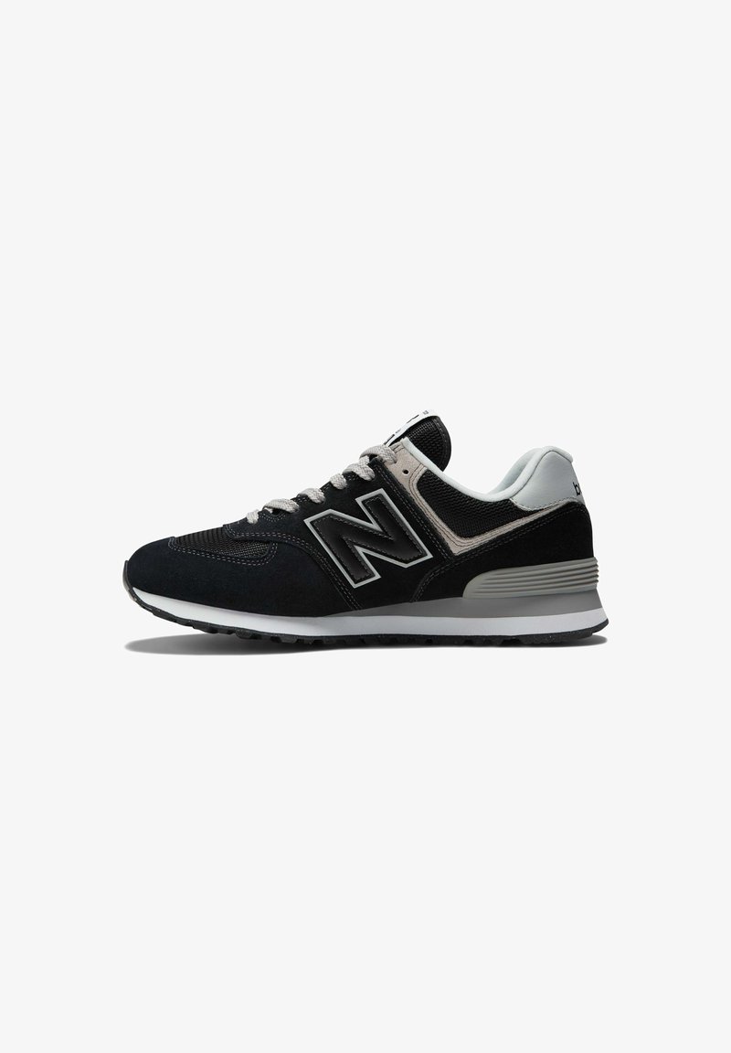 Black and grey New Balance sneaker with a suede and mesh upper, featuring a thick white sole and prominent 'N' logo on the side.