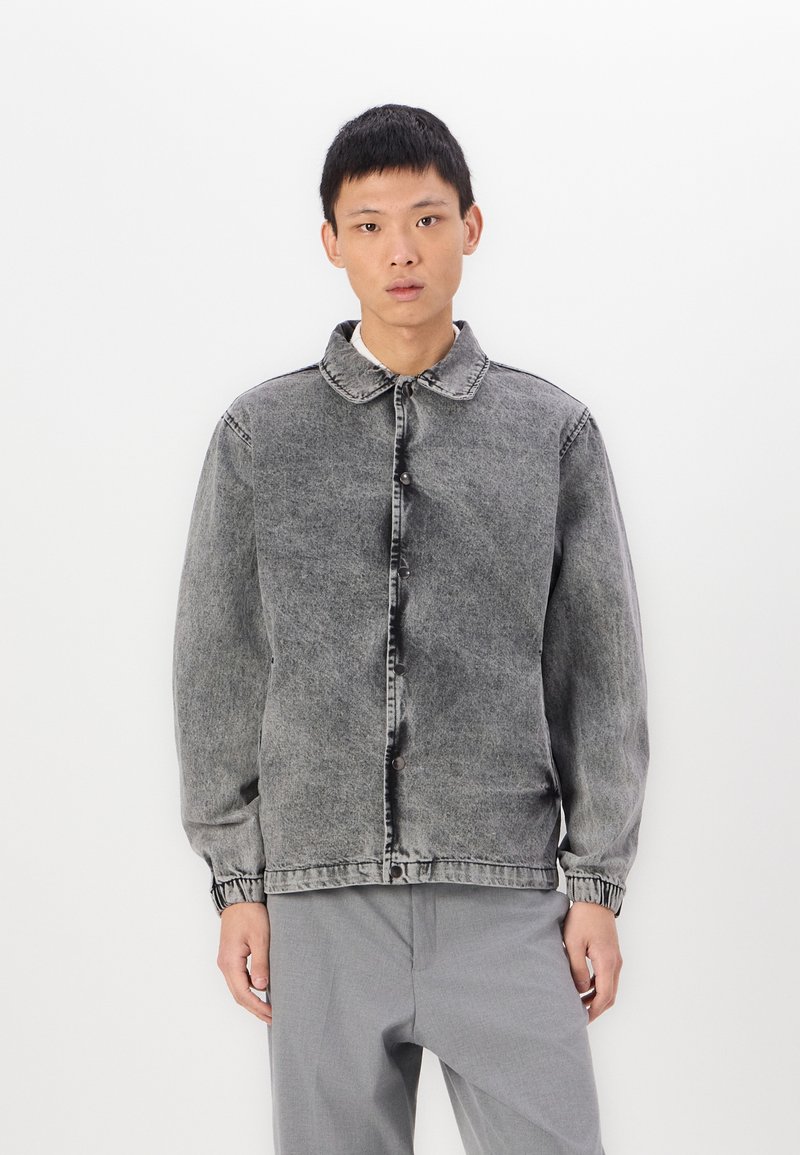 Gray denim jacket with a button closure, spread collar, and elastic cuffs. Features a faded wash and straight fit design.