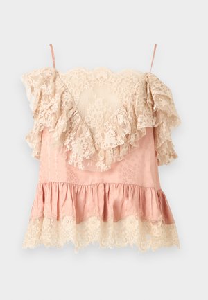 Pink satin camisole with cream floral lace ruffles along neckline, hem, and sleeves, featuring thin shoulder straps.