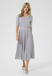 Gray striped dress with a V-neck, short sleeves, and a pleated skirt. Made of soft fabric, featuring an elastic waistband for fit.