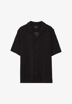 Schwarzes Kurzarmshirt mit lässiger Passform, aus strukturiertem Strickstoff mit einem Muster aus kleinen offenen Stichen und Knopfverschluss.