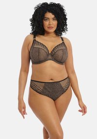 Schwarz-beige Leopardenmuster-BH und passende Unterhose aus transparenter Spitze mit strukturierten Akzenten und verstellbaren Trägern. Das Set zeichnet sich durch eine semi-transparente Optik aus.