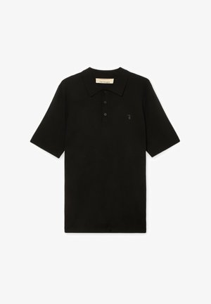 Polo nera a maniche corte con colletto a tre bottoni e piccolo logo sul lato sinistro del petto, distesa su sfondo bianco.