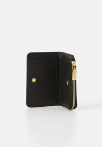 Black leather wallet with multiple card slots, gold zipper detail, and an embossed logo. Textured material enhances grip and durability.