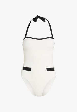 Vit texturerad baddräkt med svarta accentuerande detaljer, halterneck-design och två fickor med runda knappar framtill.