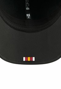 Black cap with a curved visor, featuring a colored logo in red, yellow, and white on the front. Made from durable fabric with mesh lining.