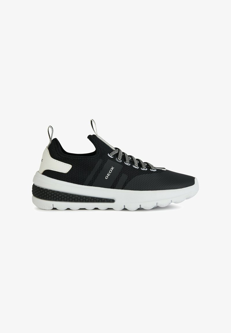 Zapatilla negra con parte superior de malla, acentos blancos y suela texturizada. Presenta un diseño de cordones y una lengüeta para ponerlas con facilidad. Logo de la marca visible.