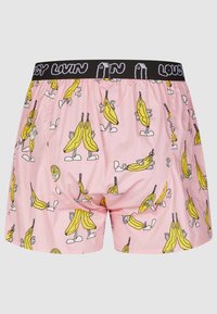 Pink boxer shorts featuring a repeated banana character pattern, with a black waistband that has "LOUSY LIVIN'" text in white.