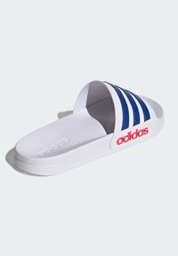 White slide sandal with three blue stripes, textured footbed, and red branding. Made from synthetic material, featuring a lightweight design.