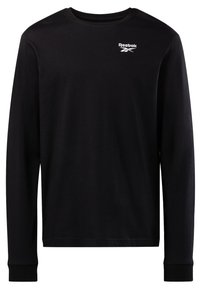 Crna dugorračna majica od pamuka s okruglim izrezom i malim bijelim Reebok logotipom na gornjem lijevom dijelu prsnog koša.