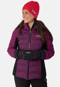 Purple and black insulated jacket with a zip front, paired with black gloves featuring pink accents, and a red knitted beanie.