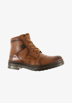 Brown leather boot with a prominent seam design, round toe, laces, and subtle branding. Features a textured sole and metal accents.