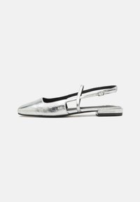 Silver metallic slingback shoe with a rounded toe, low block heel, and cut-out design on the side. Smooth texture and adjustable strap.