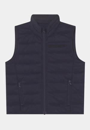 Veste matelassée sans manches bleu marine avec col montant, fermeture éclair devant et deux poches latérales zippées.