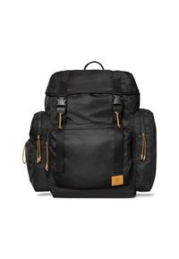 Zaino in tessuto nero con due tasche laterali, pattina superiore, spallacci regolabili e dettagli in pelle marrone. Presenta cerniere e chiusure a coulisse.