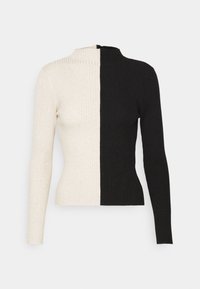 Ribbade långärmade tröja med en split-design i svart och krämfärgat. Hög krage och figurnära passform. Strukturerad tyg med vertikala ränder.