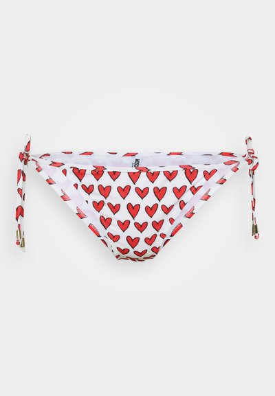 Bikini bottom featuring a white fabric with red heart prints, adjustable side ties, and smooth texture. Suitable for swimwear use.