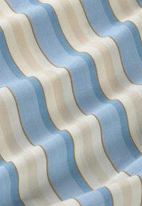 Weicher Stoff mit wellenförmigen horizontalen Streifen in Blau-, Beige- und Weißtönen, getrennt durch dünne braune Linien.