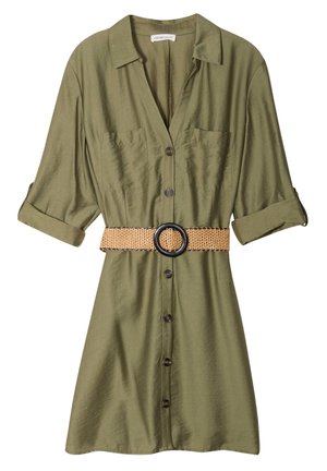 Olive green shirt dress with a collar, button front, two chest pockets, rolled sleeves, and a woven belt with a black circular buckle.