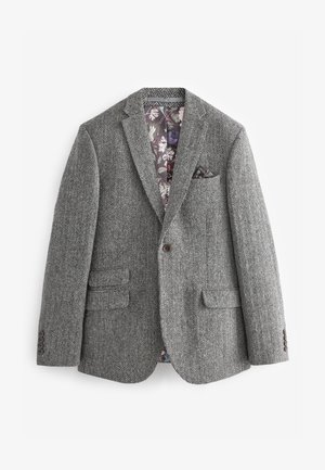 Blazer grigio a spina di pesce con rever a incavo, chiusura monopetto con un bottone, due tasche frontali e fodera floreale colorata. Accentuato da un fazzoletto da taschino.