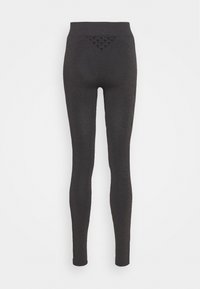 Legging noirs avec une texture lisse, taille haute et détail en maille triangulaire au dos. Design ajusté pour une silhouette élancée.