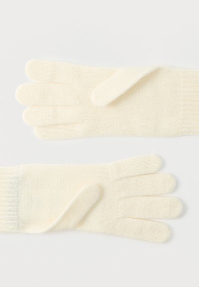 Κρεμ-χρώματος πλεκτά γάντια με απαλό υφή, διαθέτουν σχεδιασμό με πέντε δάχτυλα και ριμπ μανσέτα στον καρπό. Χωρίς πρόσθετα σχέδια ή διακοσμήσεις.