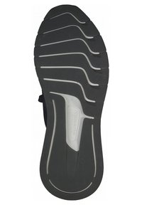 Semelle en caoutchouc noir et blanc avec des motifs ondulés et striés, portant la marque "Tamaris" au centre.