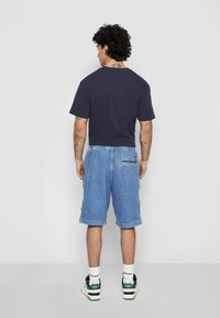 Tommy Jeans AIDEN TAPE - Denim shorts - denim light