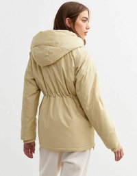 Beige padded jacket with a cinched waist, drawstring hood, elastic cuffs, and smooth texture, featuring a minimalistic design.
