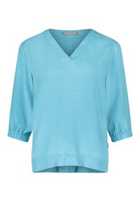 Light blue, three-quarter sleeve blouse with a V-neck and gathered cuffs. Smooth fabric with a slight sheen and a relaxed fit.