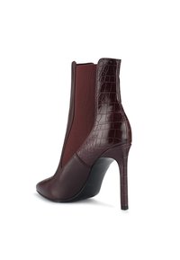 Burgundy ankle boot featuring a pointed toe, sleek leather with croc-embossed accents, elastic side panels, and a high stiletto heel.