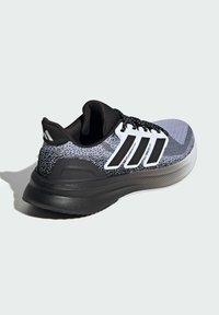 Sport shoes featuring a black and gray knit upper, black sole, white stripes on the side, and a padded collar for comfort.