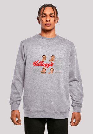 Gray sweatshirt featuring a front graphic with four vintage child images and a bold red "Kellogg's" logo. Ribbed cuffs and crew neck design.