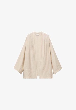 Beige kimono med breda ärmar, tillverkad av texturerad tyg. Öppen front utan knäppningar och en avslappnad silhuett.