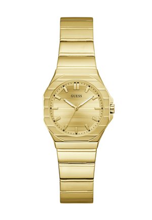 Montre-bracelet Guess dorée avec bracelet en maillons métalliques, cadran rond, index horaires minimalistes et trois aiguilles indiquant 1:10:36.